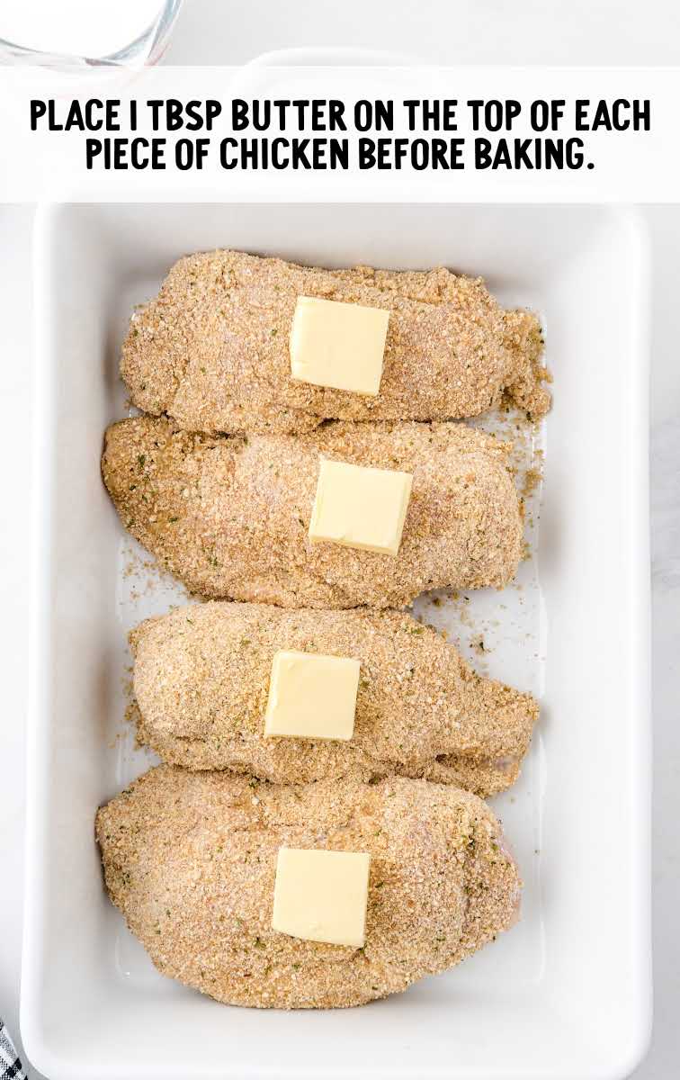 chicken cordon bleu process shot of slices of butter placed on top of chicken in a baking dish