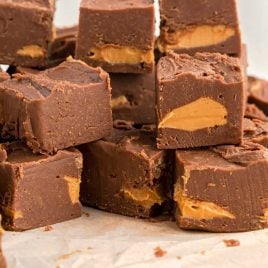 close up shot of chocolate peanut butter fudge stacked on top of each other
