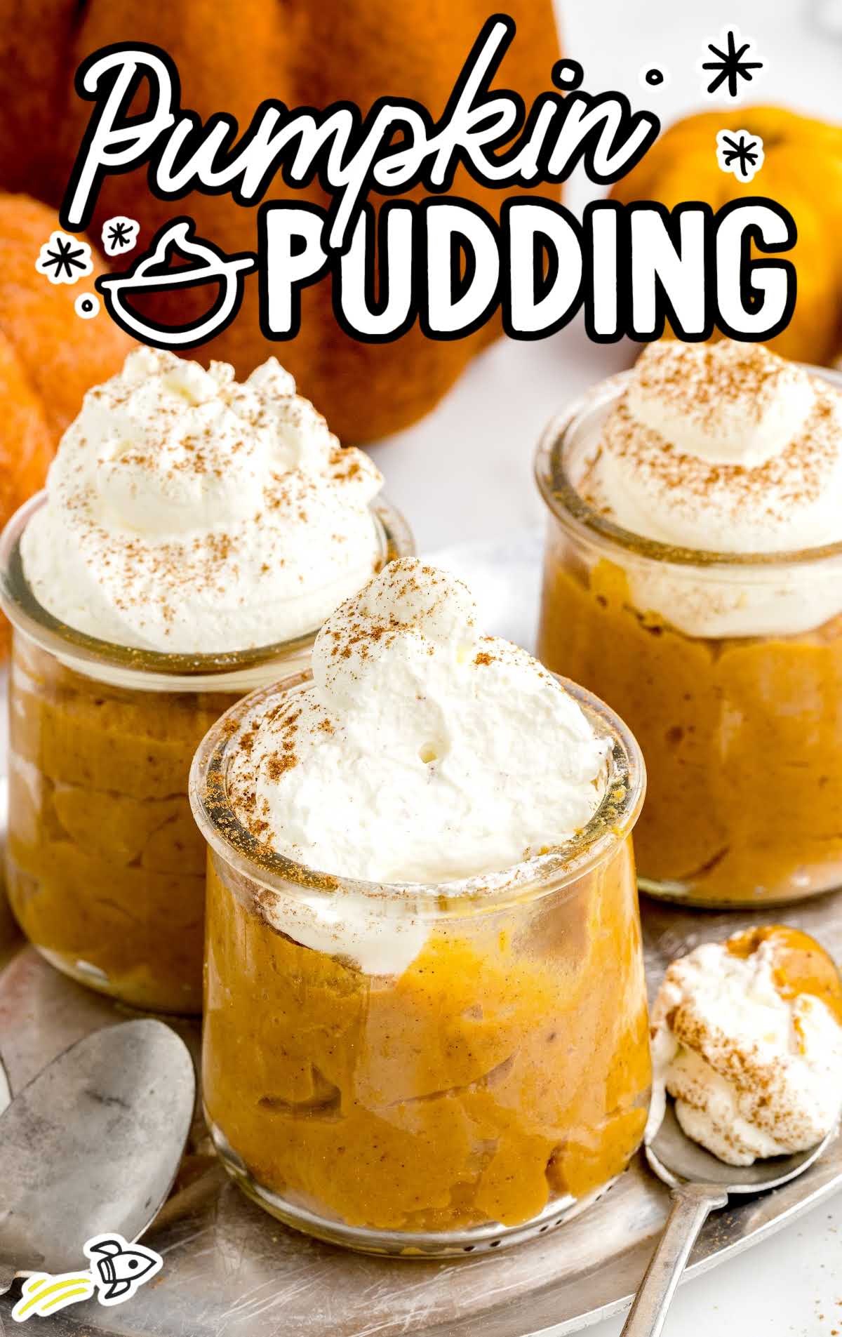 close up shot of cups of Pumpkin Pudding topped with whipped cream and cinnamon
