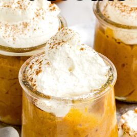 a close up shot of cups of Pumpkin Pudding topped with whipped cream