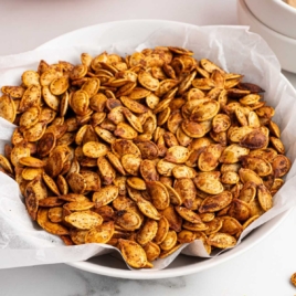 Bowl of oven roasted pumpkin seeds served as a crunchy snack