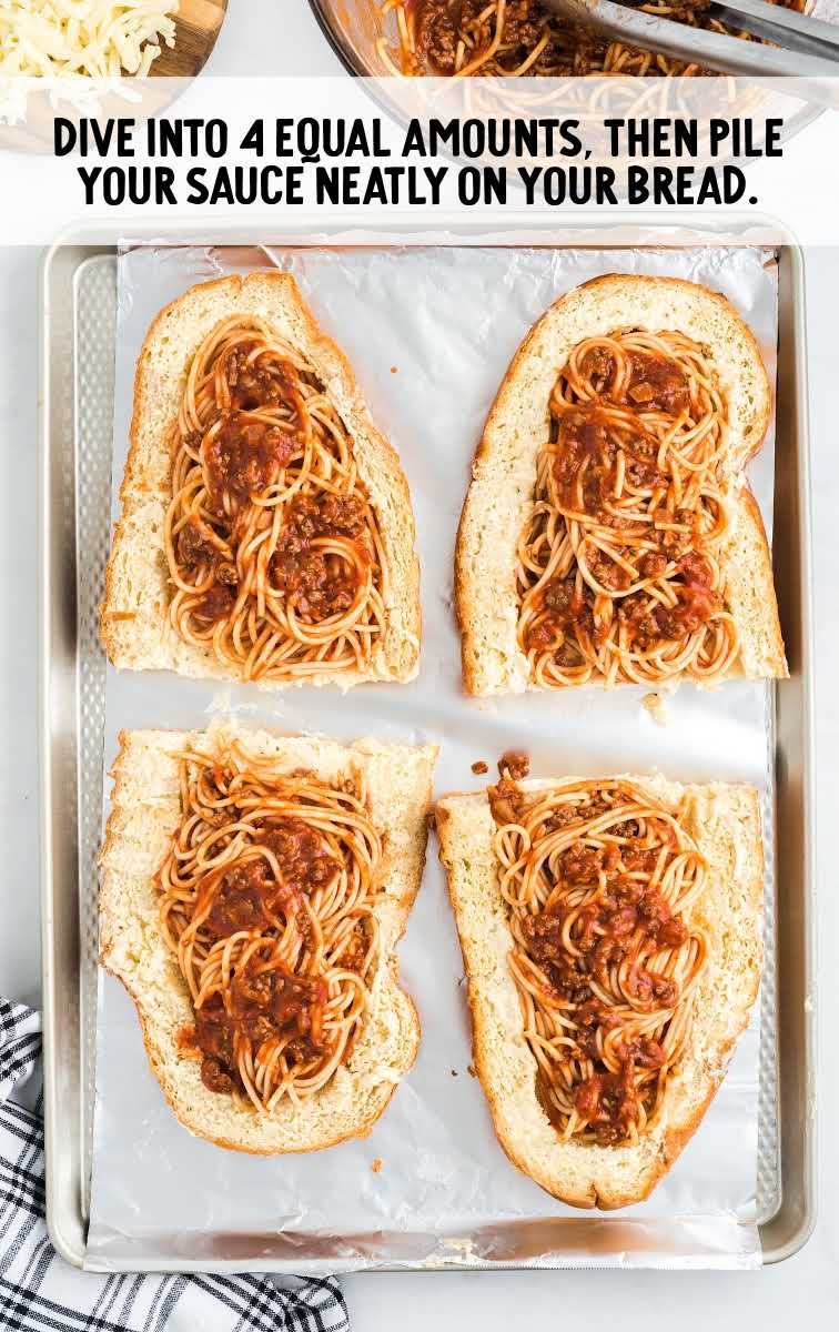 spaghetti stuffed garlic bread process shot of spaghetti being piled on top of slices of bread
