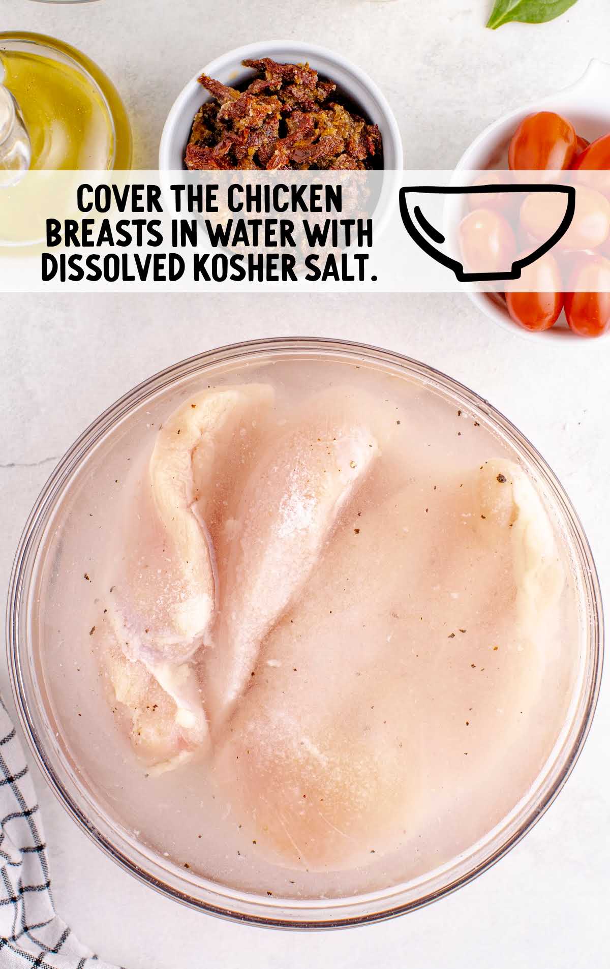 chicken breast covered in water with kosher salt