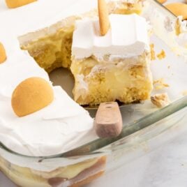 a slice of Banana Pudding Cake taken out of the baking dish