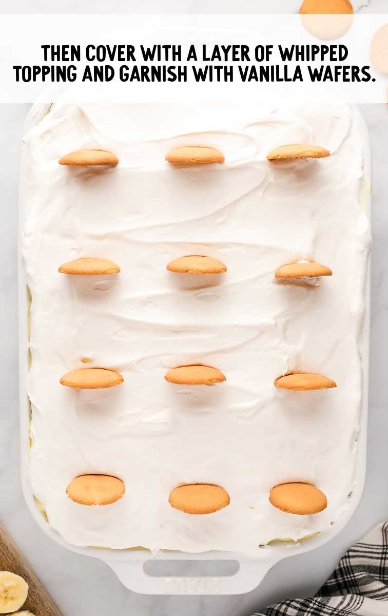 Banana Pudding Cake process shot of vanilla wafers being placed on top of cake