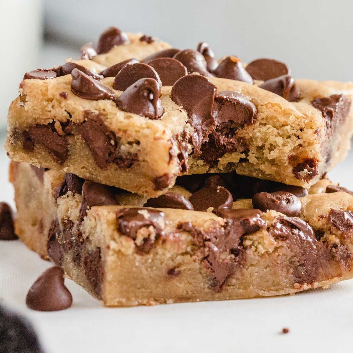 close up shot of dessert bars stacked on top of each other