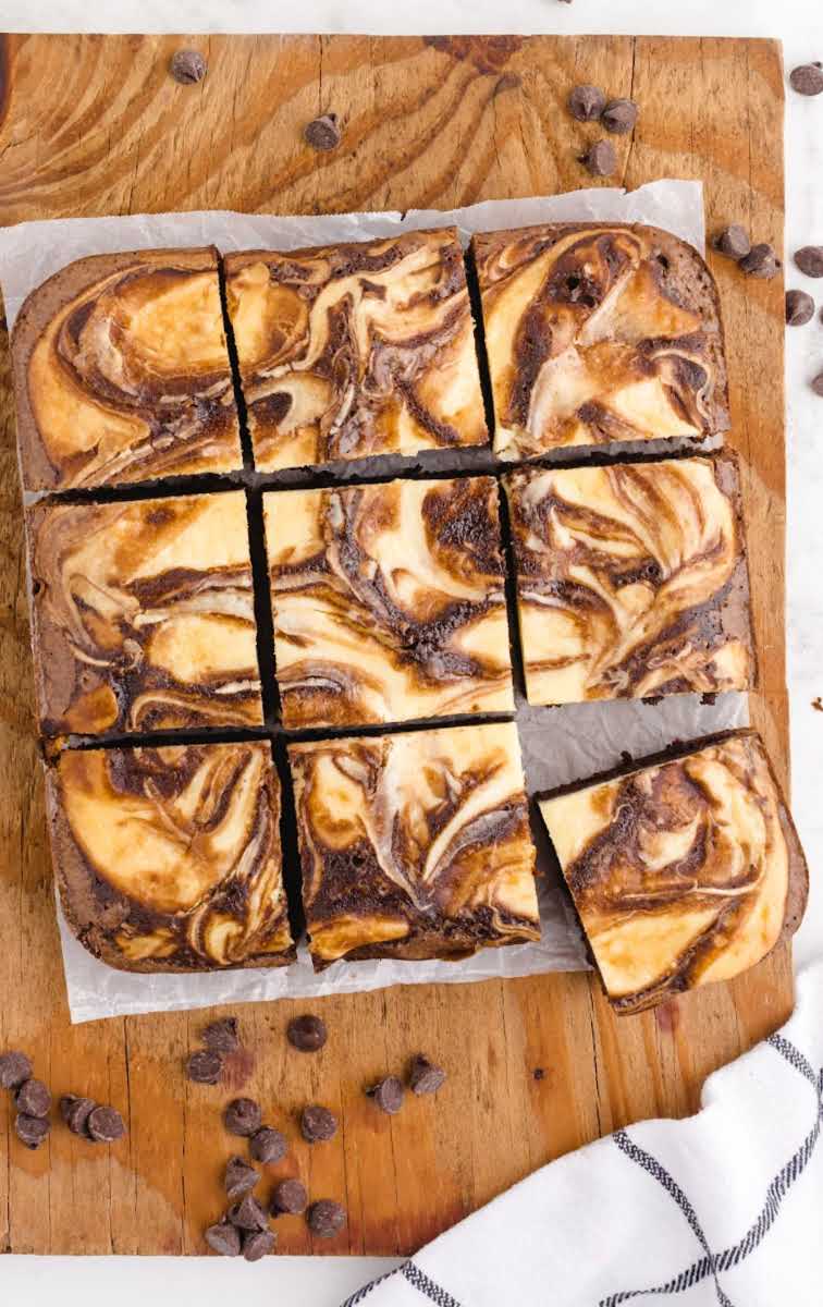 close up overhead shot of Cheesecake Brownies on a wooden board