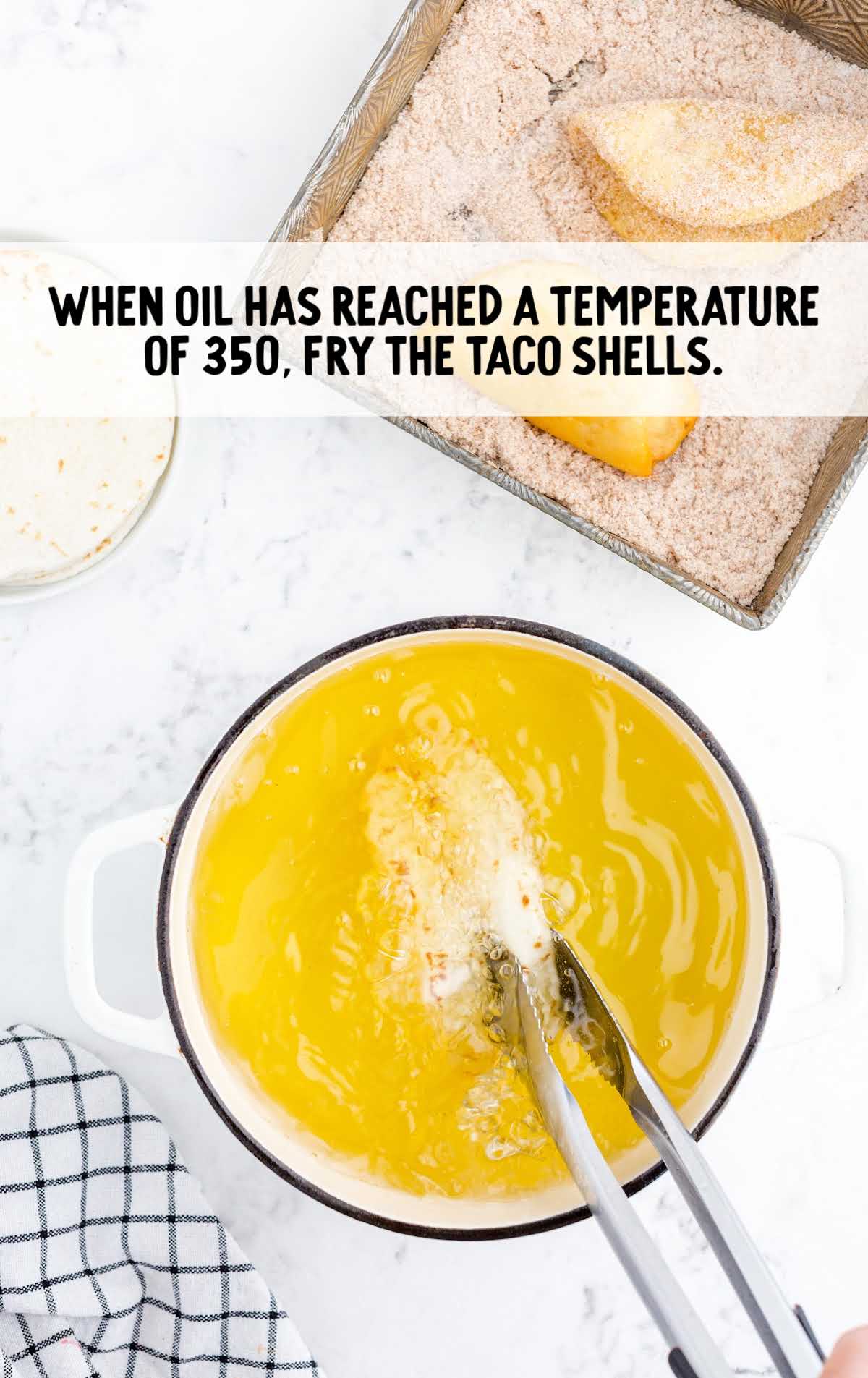 place taco shells into the oil