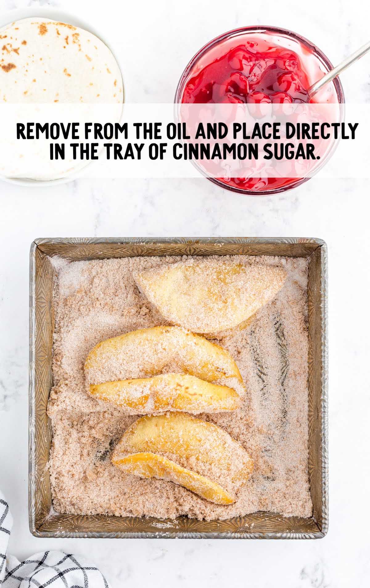 place tacos on a tray of cinnamon sugar