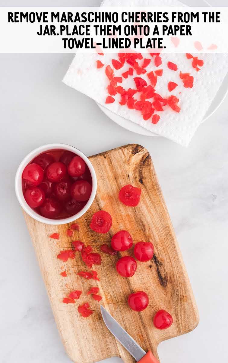 cherries being diced on a wooden board