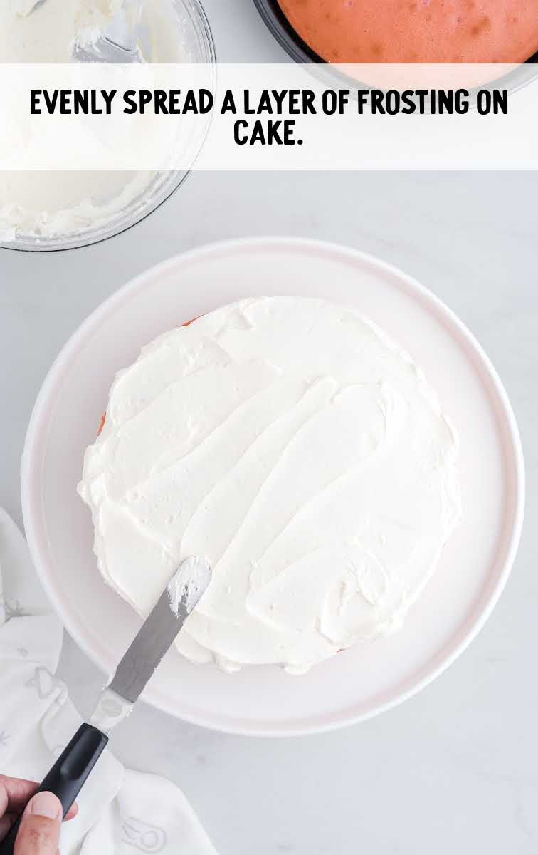 frosting being spread over the cake