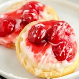cherry danish topped with glaze on a plate