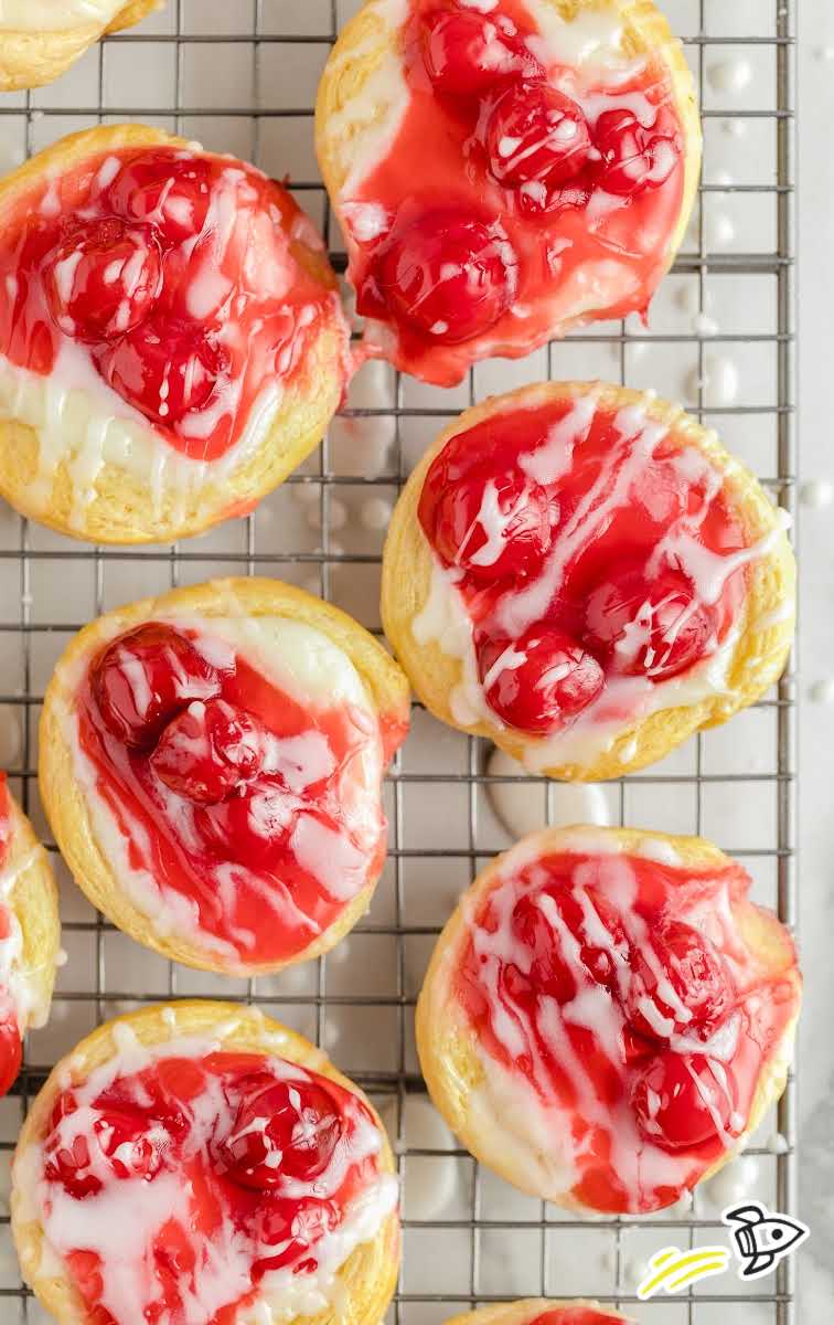 overhead shot of cherry danish with topped with glaze on a cooling rack