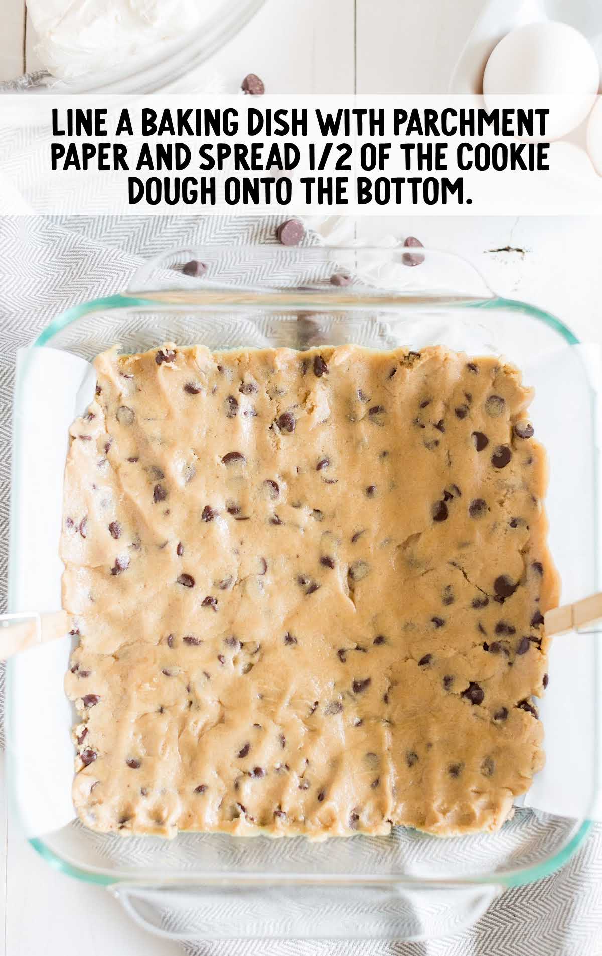 cookie dough spread into the bottom of a baking dish