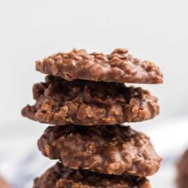 a close up shot of Chocolate Peanut Butter No-Bake Cookies stacked on top of each other