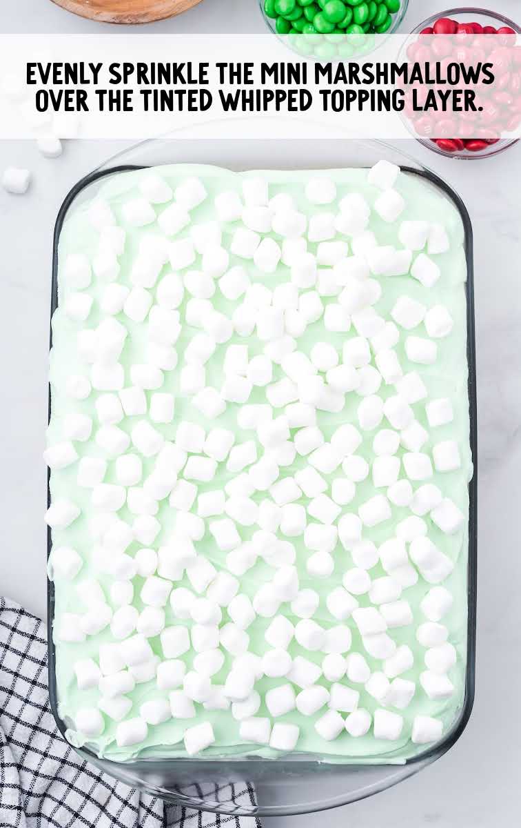 Christmas Red Velvet Poke Cake process shot of mini marshmallows sprinkled on top of the cake