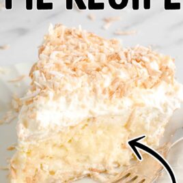 close up shot of a slice of Coconut Cream Pie on a plate with a fork