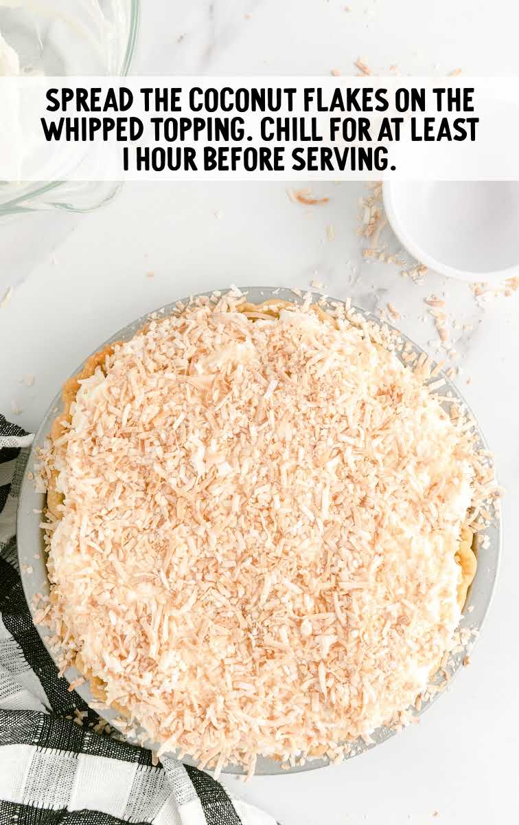 coconut flakes spread over the whipped topping on the coconut cream pie