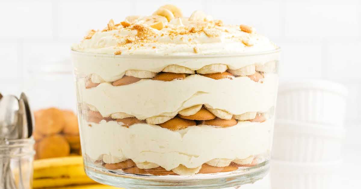 close up shot of a bowl of copycat magnolia banana pudding topped with banana slices and crushed vanilla wafers