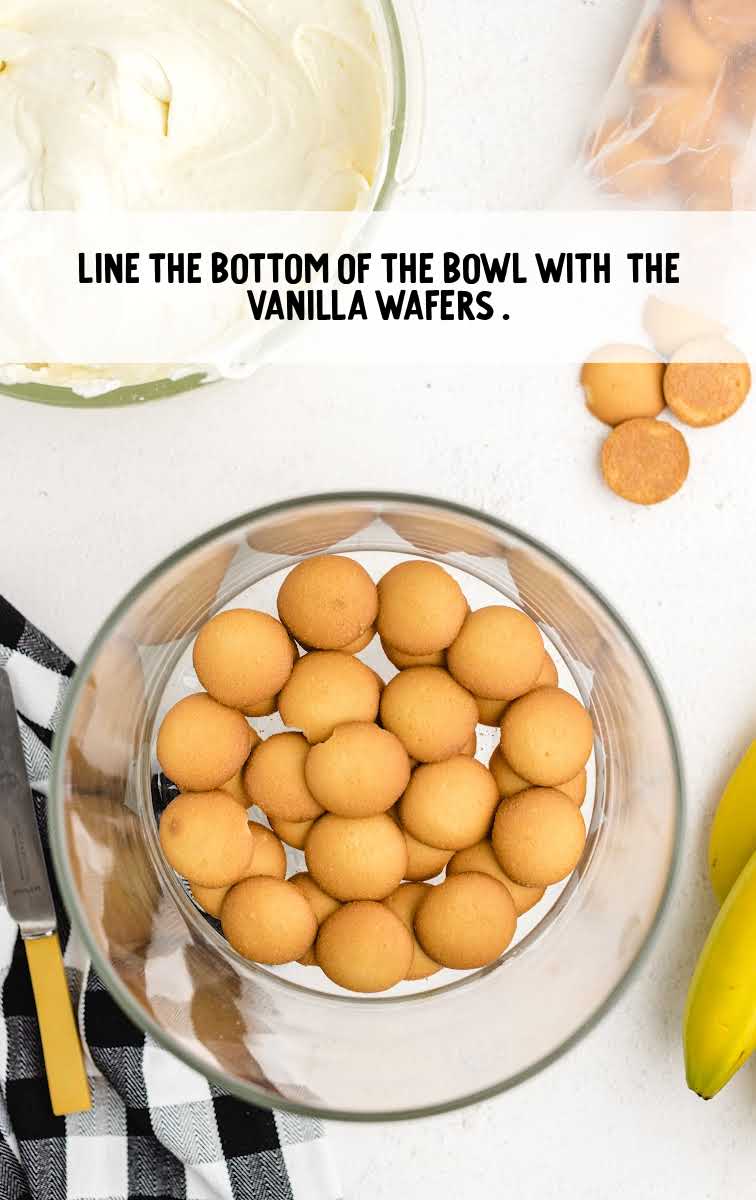 copycat magnolia banana pudding process shot of vanilla wafers lined on the bottom of a bowl