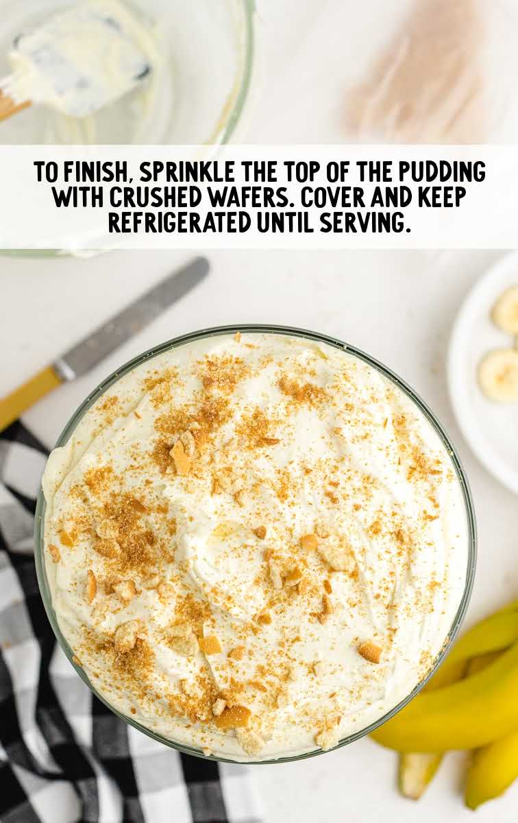 copycat magnolia banana pudding process shot of crushed wafers sprinkled on top of pudding