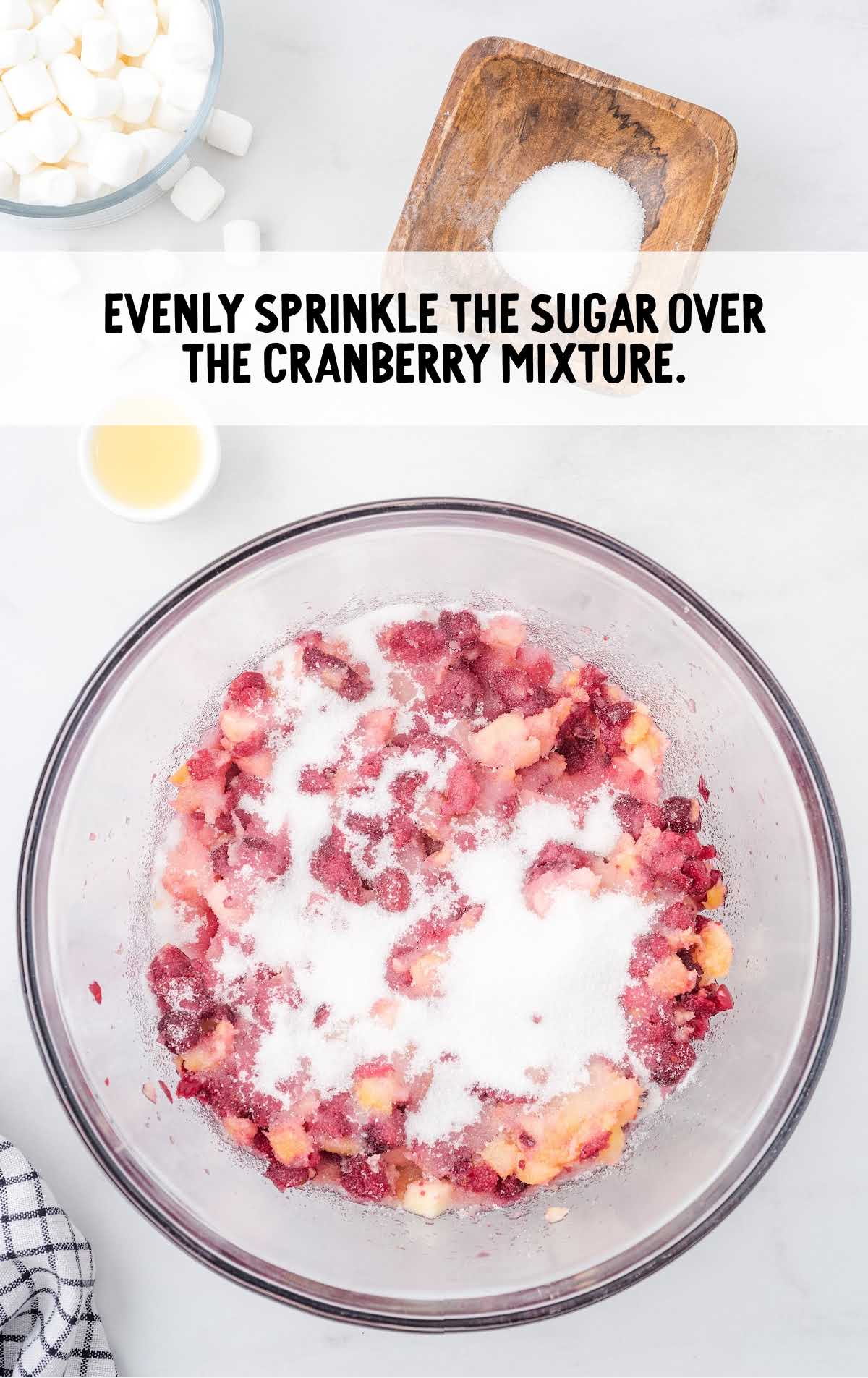 sugar sprinkled over the cranberry mixture in a bowl