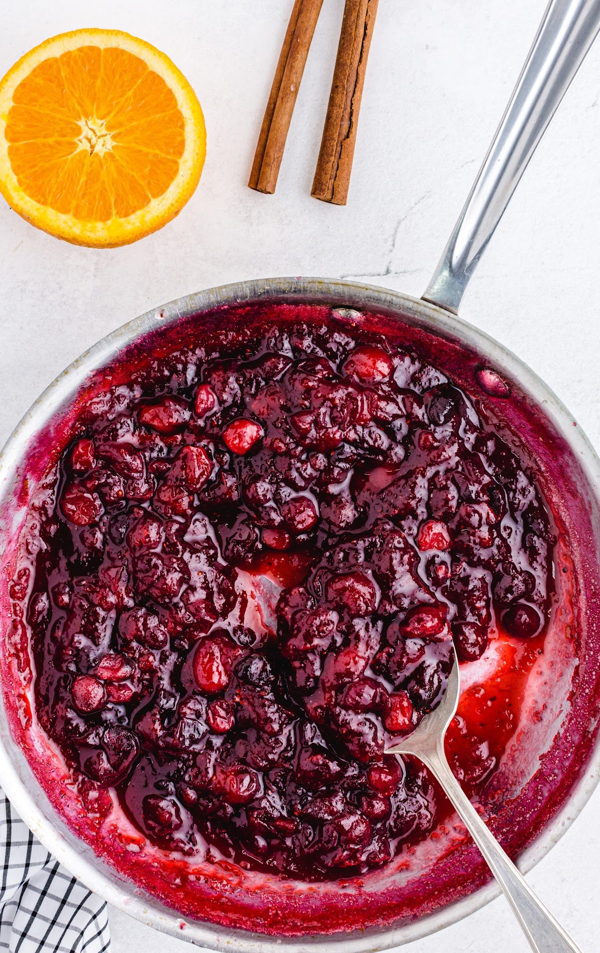 close up shot of a pan of Cranberry Sauce with a spoon