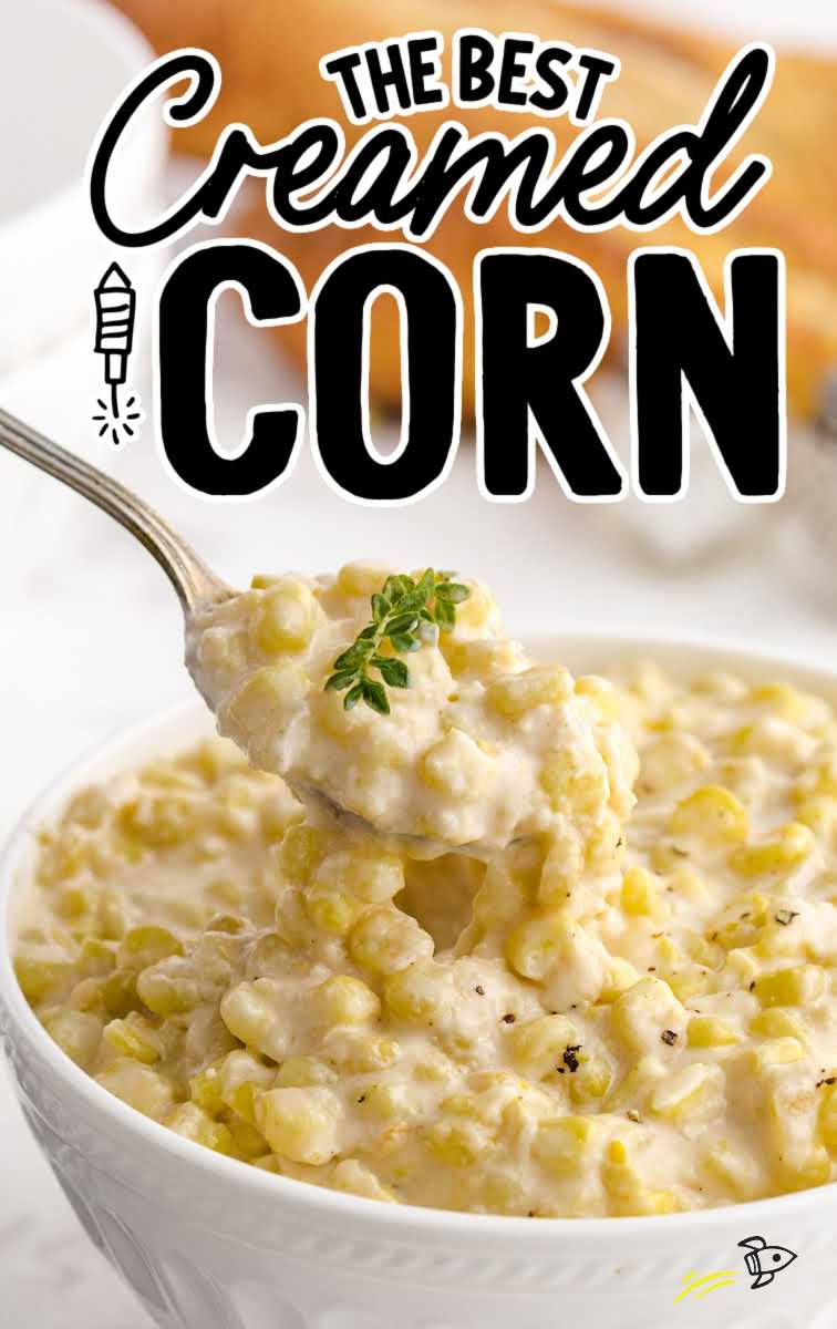 a close up shot of Creamed corn in a bowl with a fork grabbing a piece 