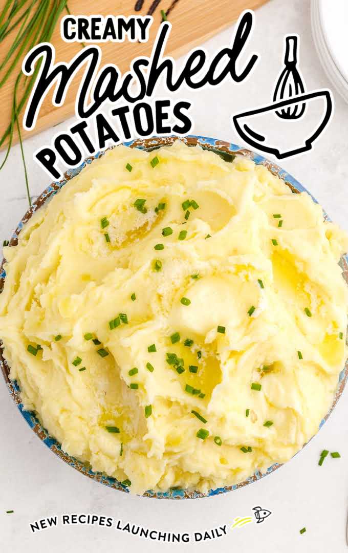 close up overhead shot of a bowl of Creamy Mashed Potatoes garnished with chives