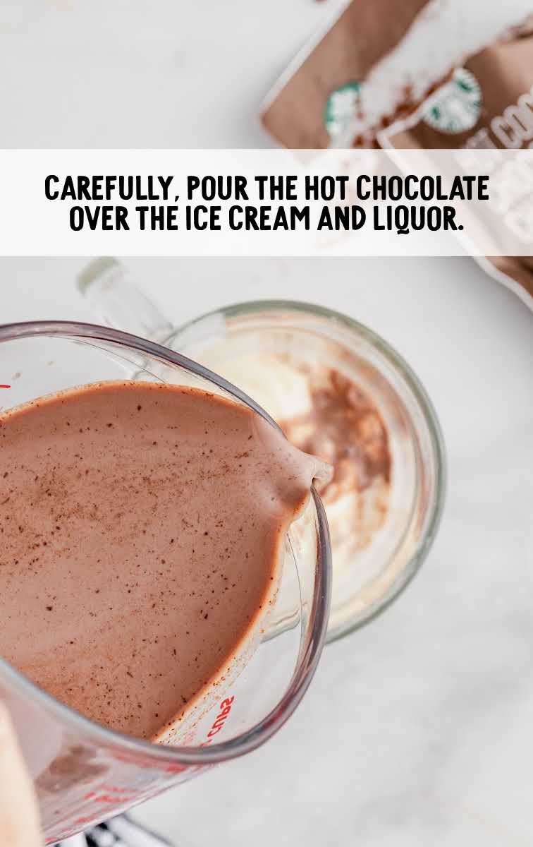 hot chocolate being poured into a cup of ingredients