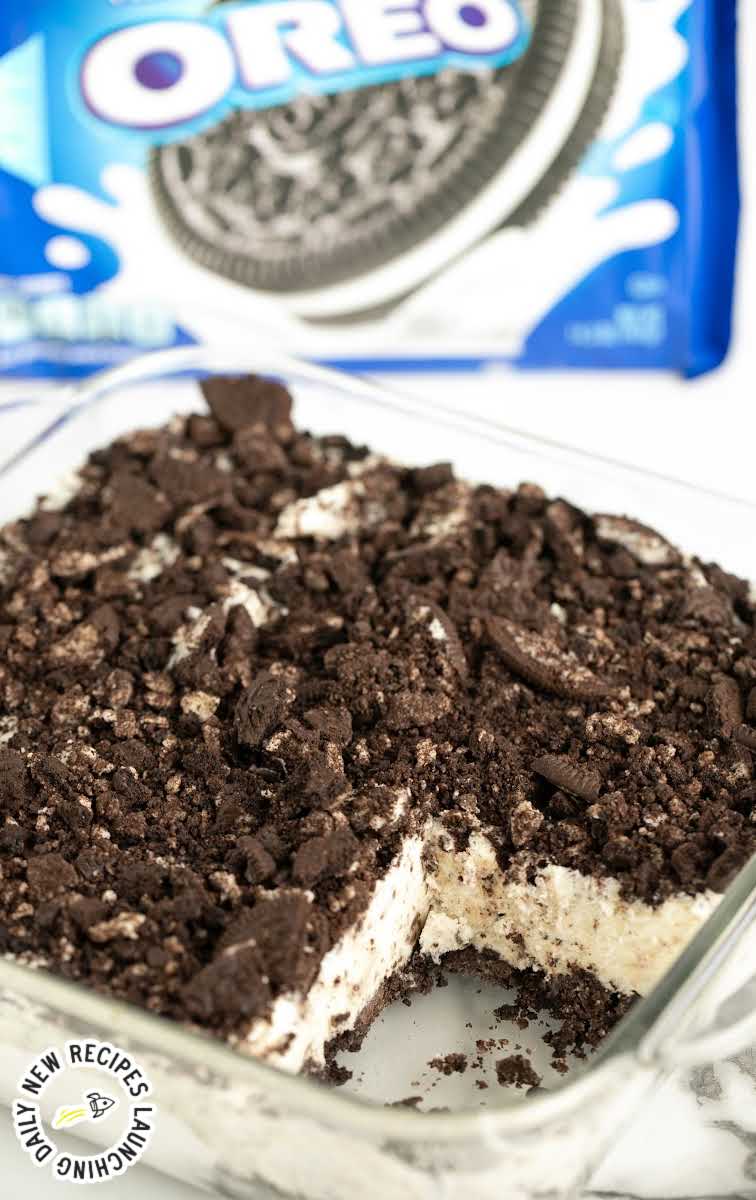 close up shot of Easy Frozen Oreo Dessert in a baking dish with a pack of oreos in the back