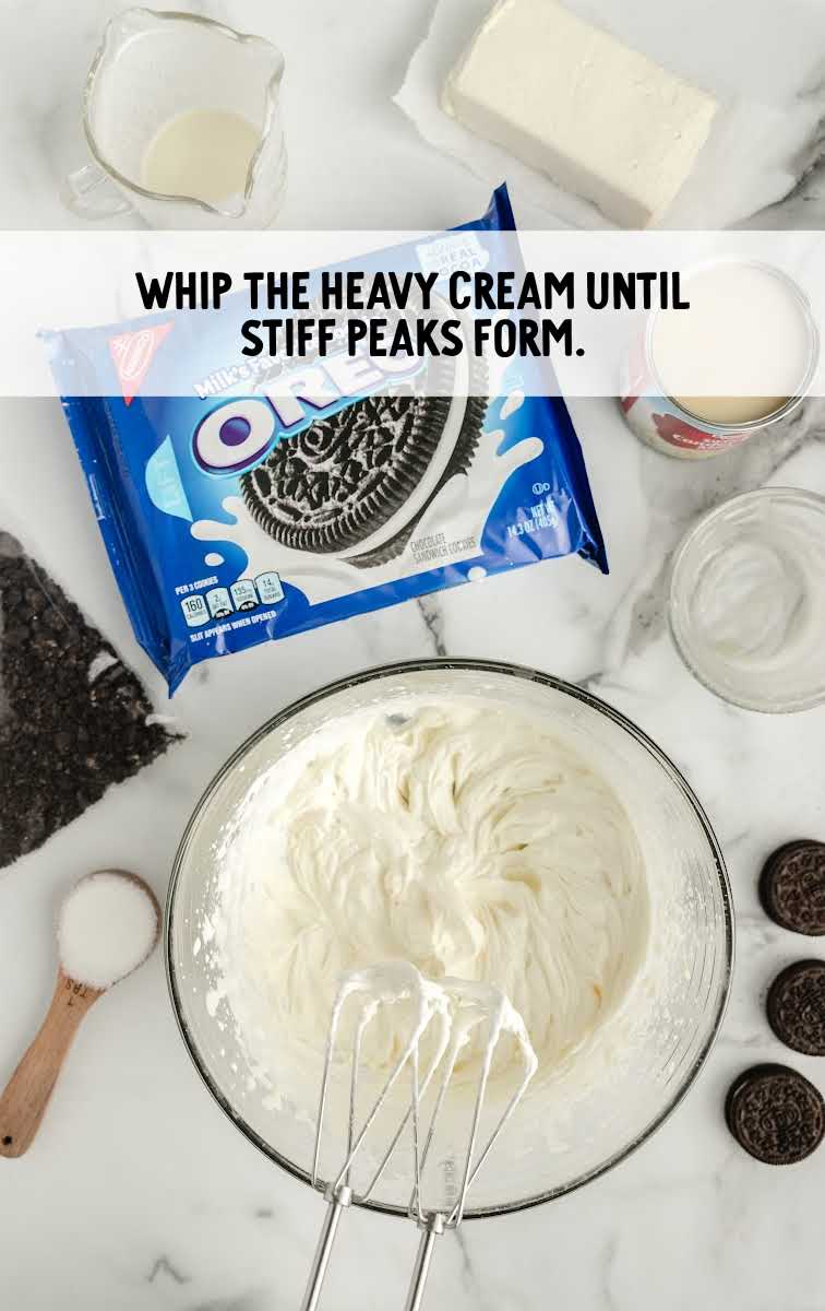 Easy Frozen Oreo Dessert process shot of heavy cream being whipped in a bowl
