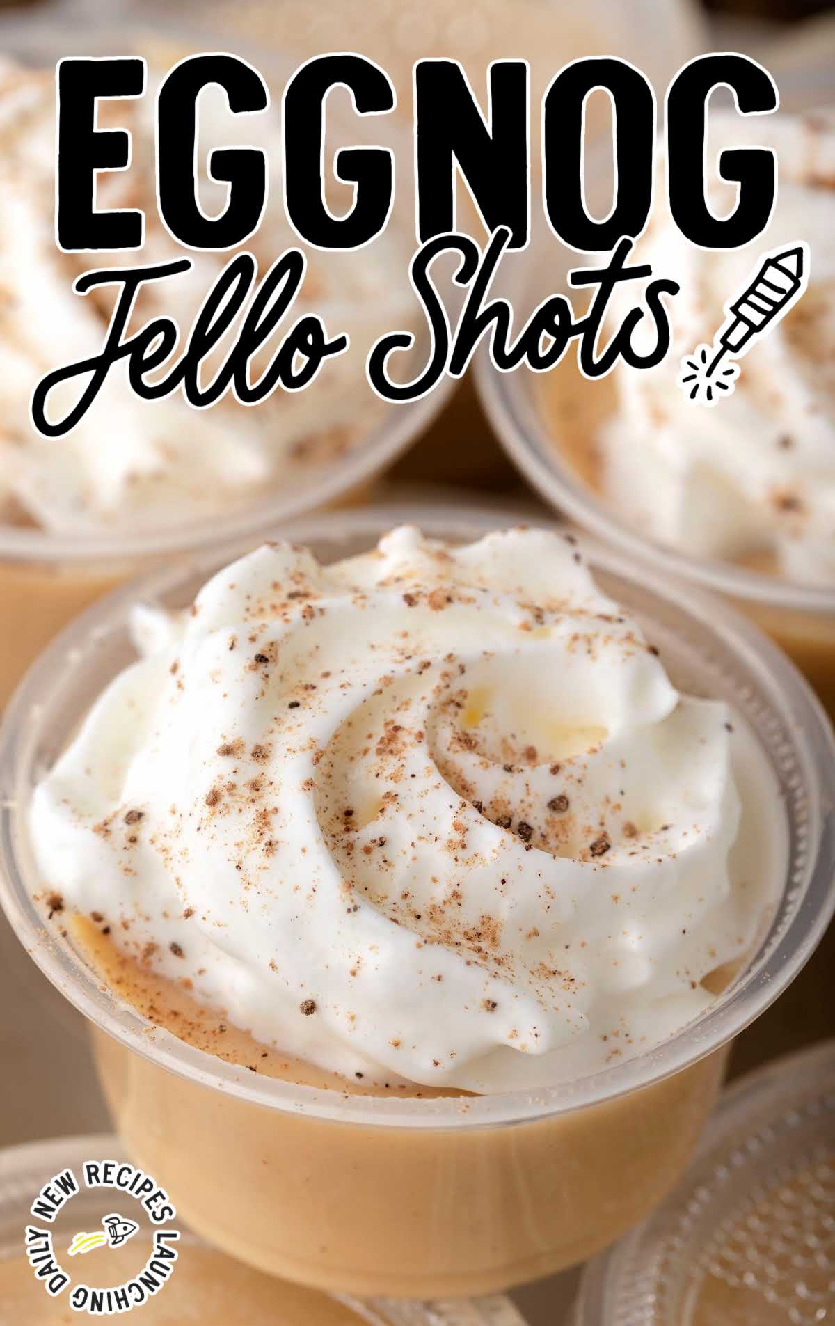 close up shot of Eggnog Jello Shots topped with whipped cream