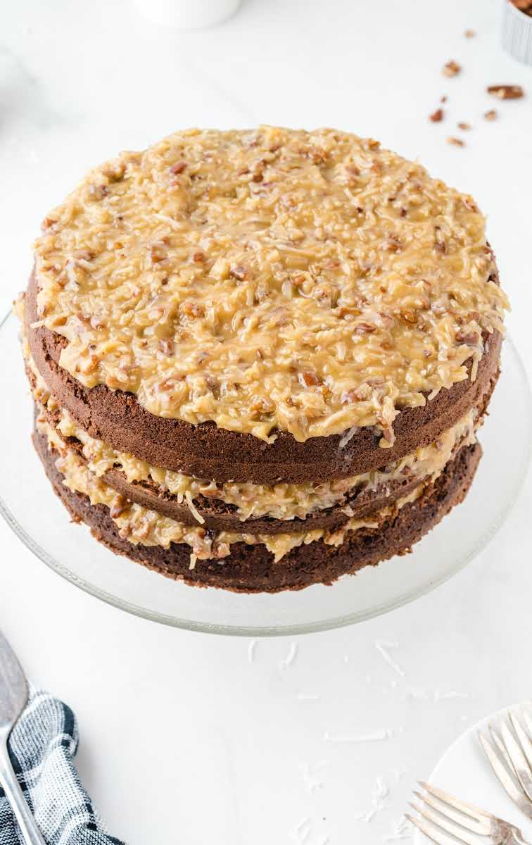 close up shot of German Chocolate Cake with coconut pecan frosting on a serving dish
