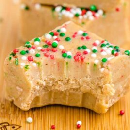 close up shot of Gingerbread Fudge with sprinkles on a wooden board