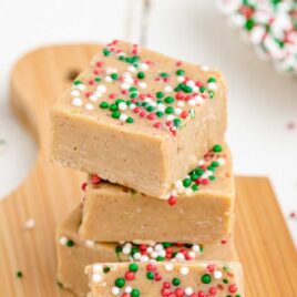 close up shot of Gingerbread Fudge with sprinkles on a wooden board