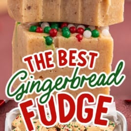 Two stacked pieces of gingerbread fudge with red, green, and white sprinkles rest above a tray full of cut fudge squares. Text reads: The Best Gingerbread Fudge. Vintage Recipe! Try this classic Gingerbread Fudge Recipe for a festive treat everyone will love.