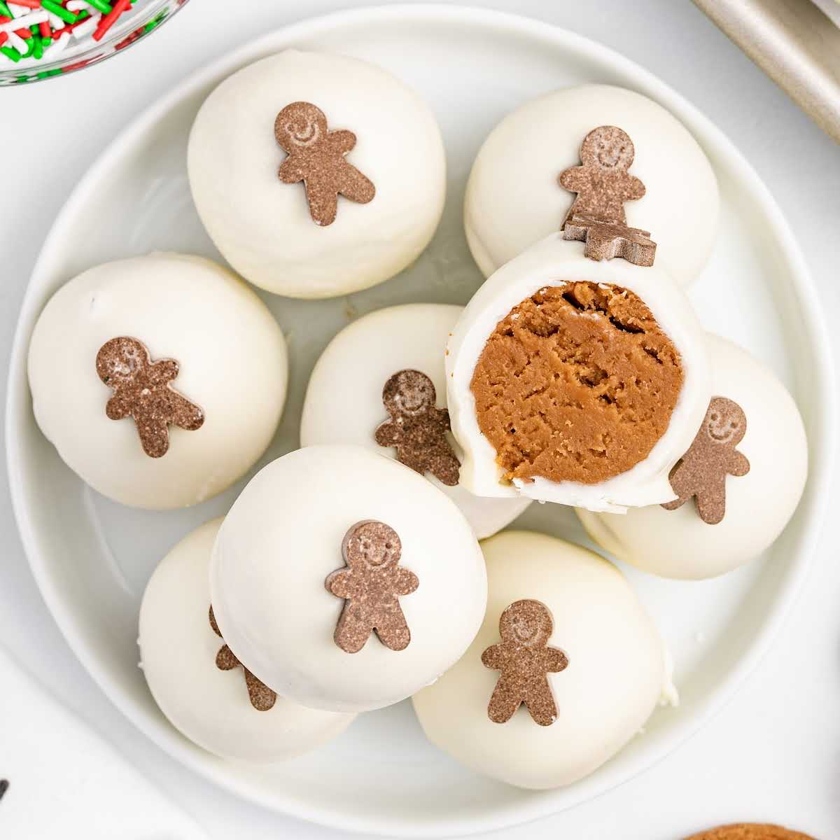 close up shot of Gingerbread Truffles piled on a plate with a bite taken out of one of them