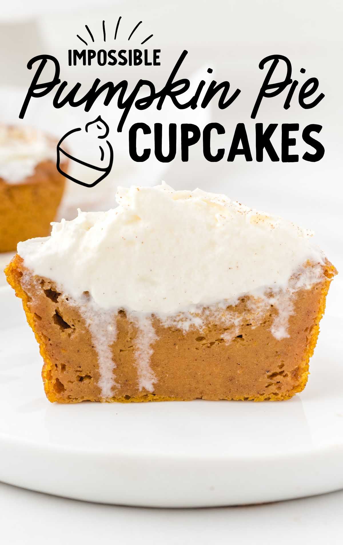 close up shot of impossible pumpkin pie cupcakes topped with whip cream on a white plate