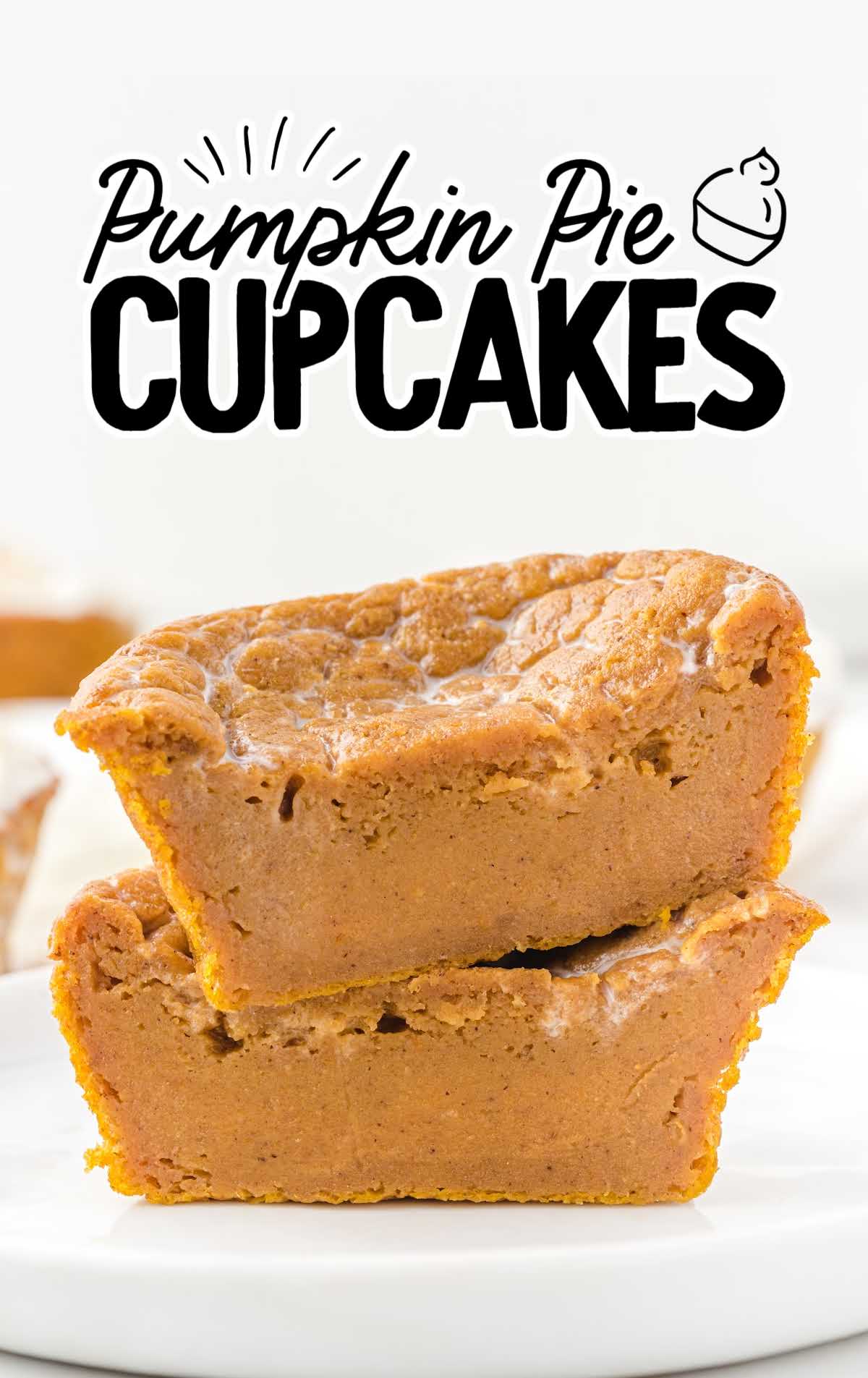 Two stacked pumpkin pie cupcakes without topping, showing dense, smooth pumpkin filling.
