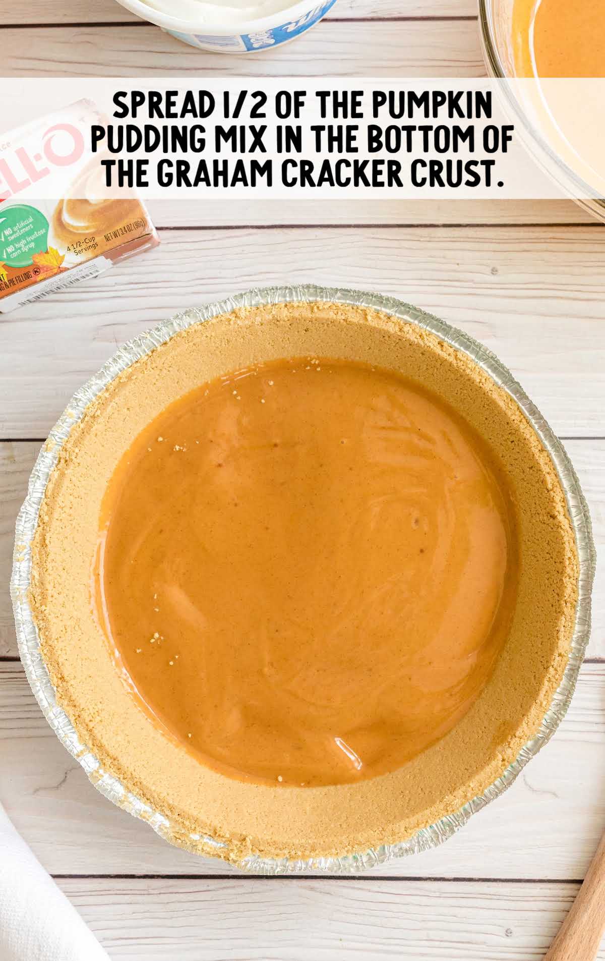 Mixing bowl with creamy orange pumpkin spice filling being whisked together for the pie.