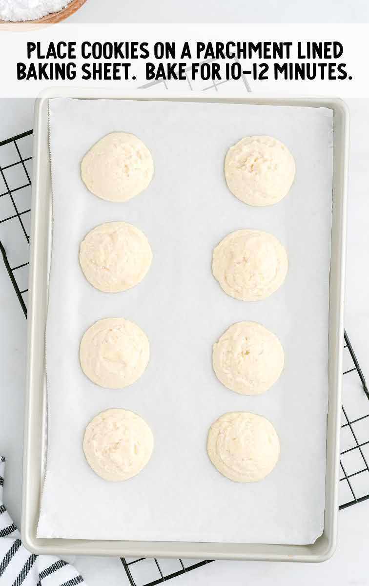Peppermint Meltaways process shot of cookies placed on a parchment lined baking sheet then being baked