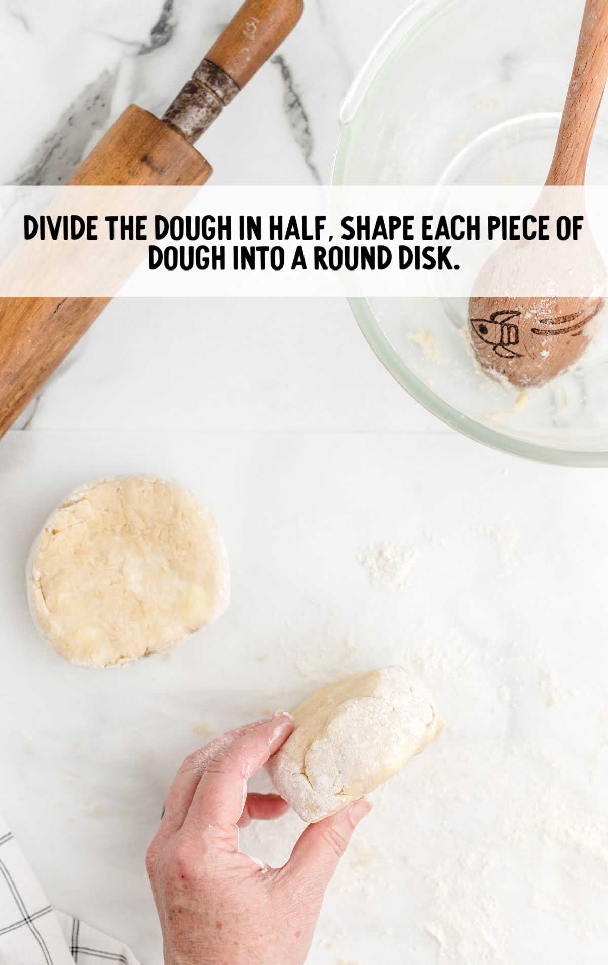 dough divided into half and shaped into a round disk
