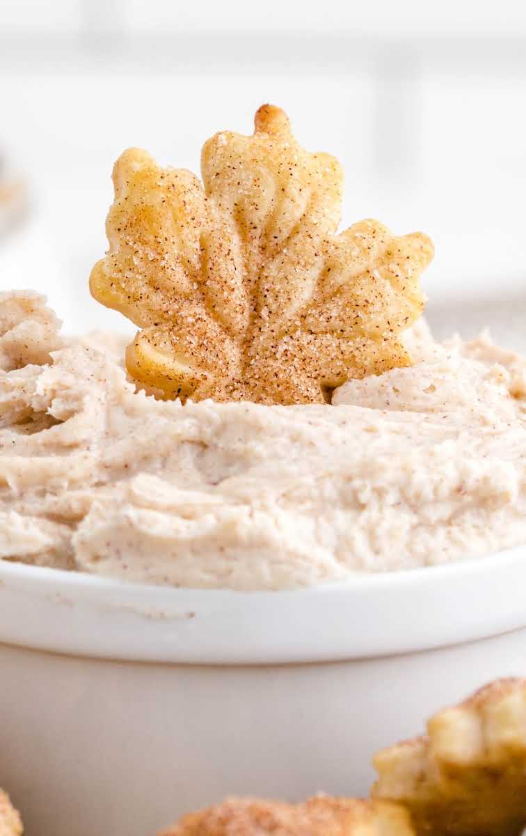 close up shot of pie crust chips with a bowl of cinnamon dip