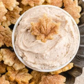 close up overhead shot of pie crust chips on a plate with a bowl of cinnamon dip