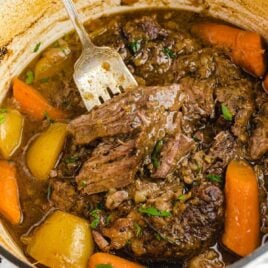 close up shot of a pot of Pot Roast garnished with parsley
