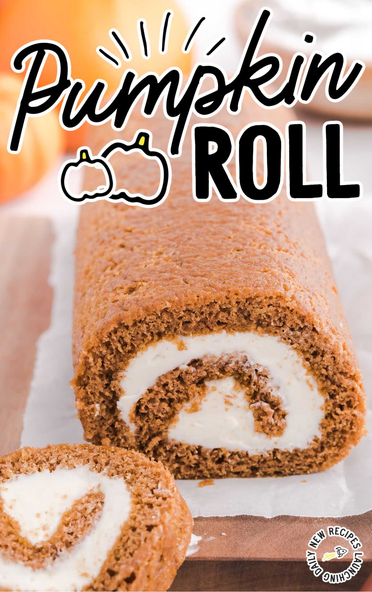 close up shot of pumpkin roll with a slice removed on a wooden board