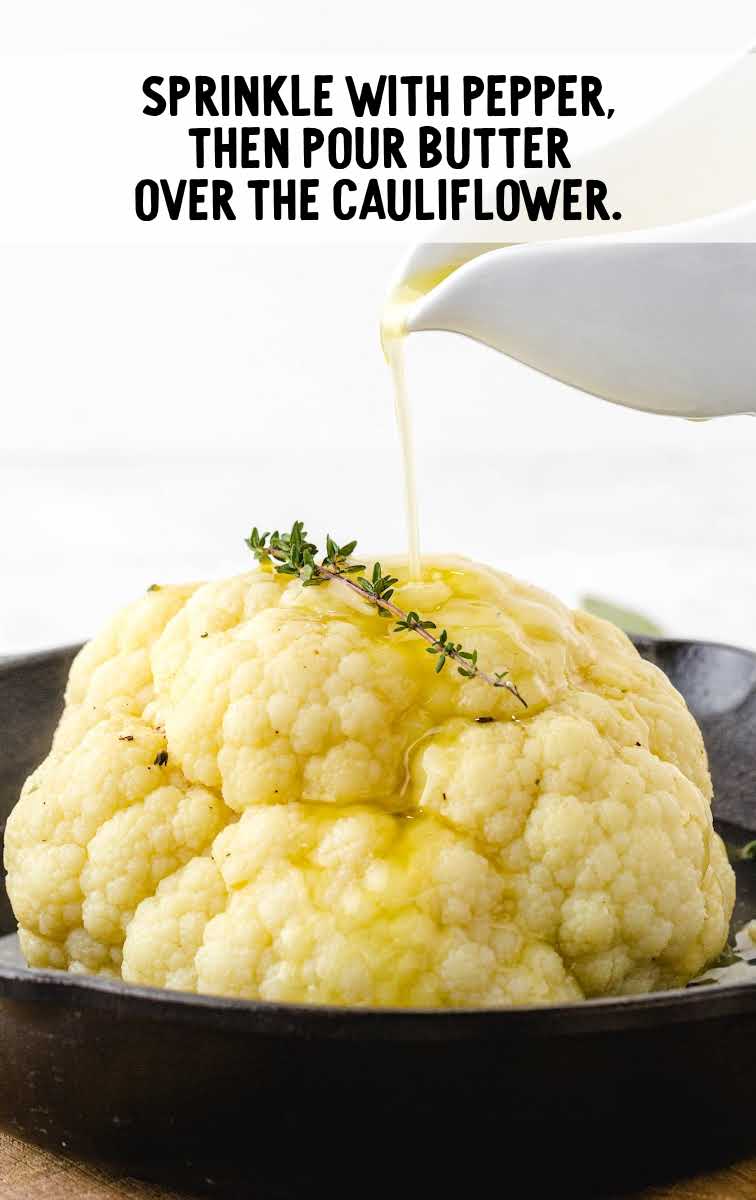 Roasted Cauliflower process shot of butter poured on top of cauliflower in a skillet
