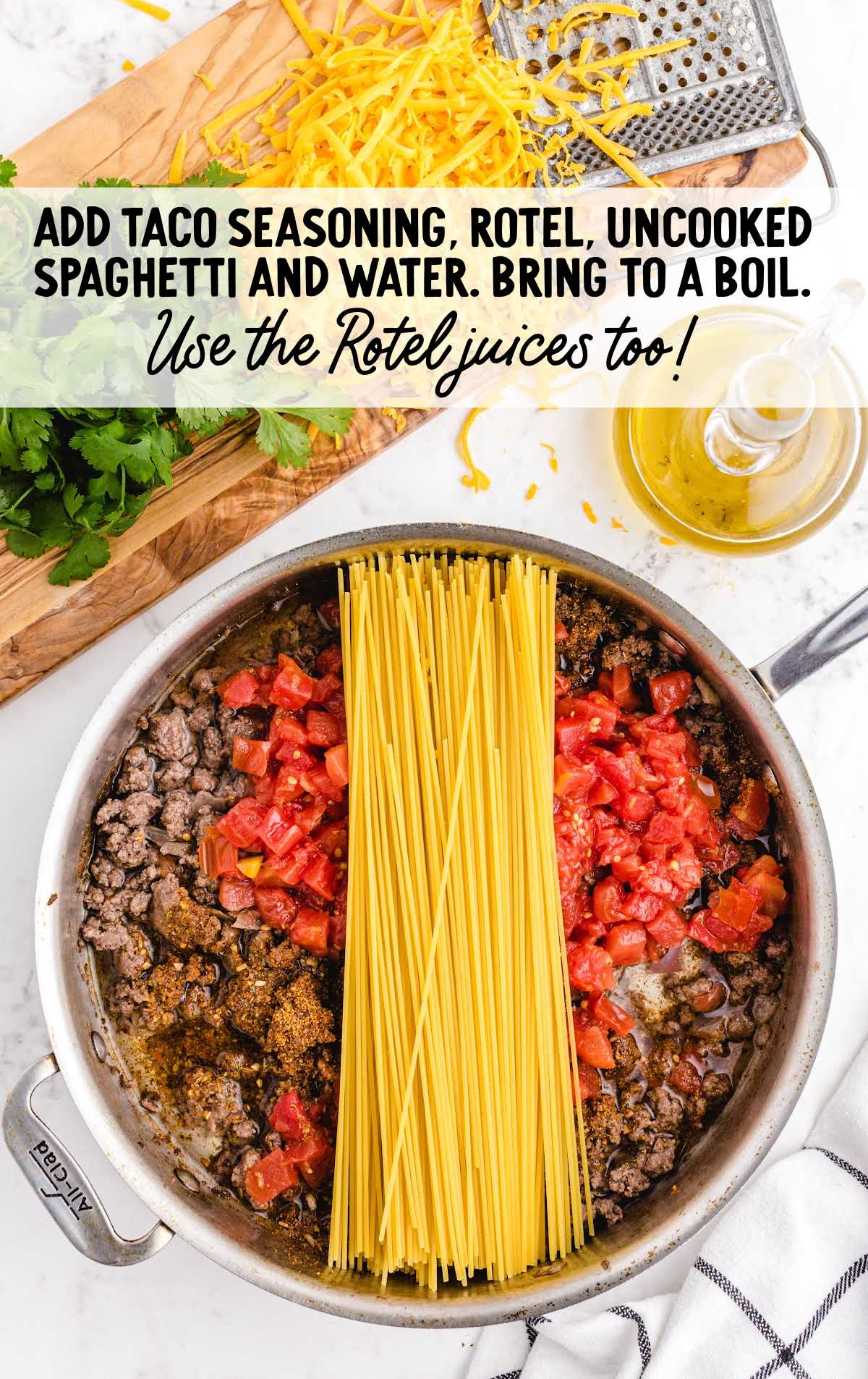 taco seasoning, Rotel, spaghetti, and water added to the skillet of cooked ground beef