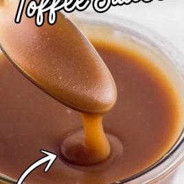 close up shot of a jar of Toffee Sauce with a spoon dipped into the jar